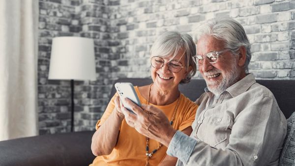 senior citizens looking at apps on mobile phone