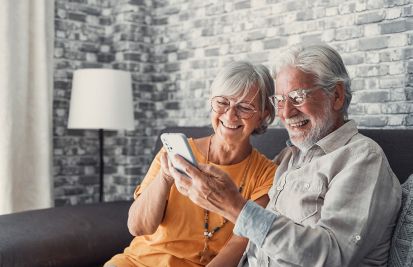 senior citizens looking at apps on mobile phone