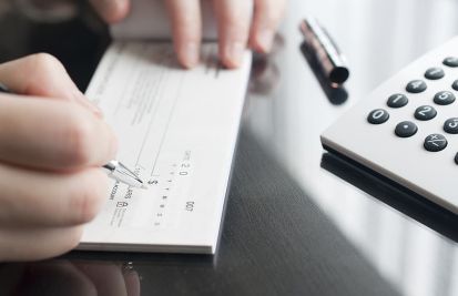 woman signing a check