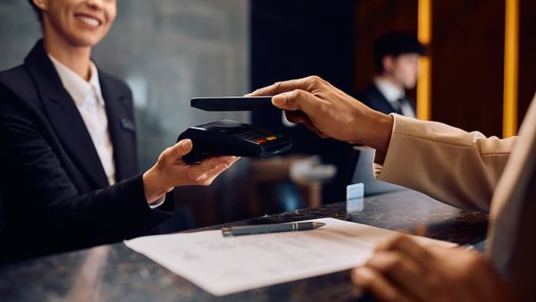 woman helping a customer with a credit card terminal