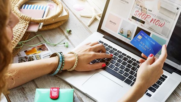 woman using credit card on laptop for holiday sale