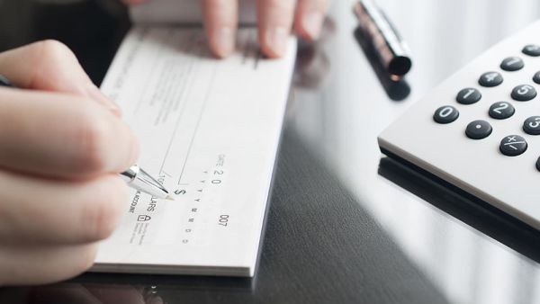 woman signing a check