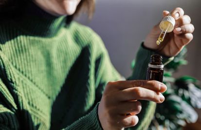 woman holding cbd droplet bottle