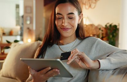 woman on laptop with credit card on ecommerce site