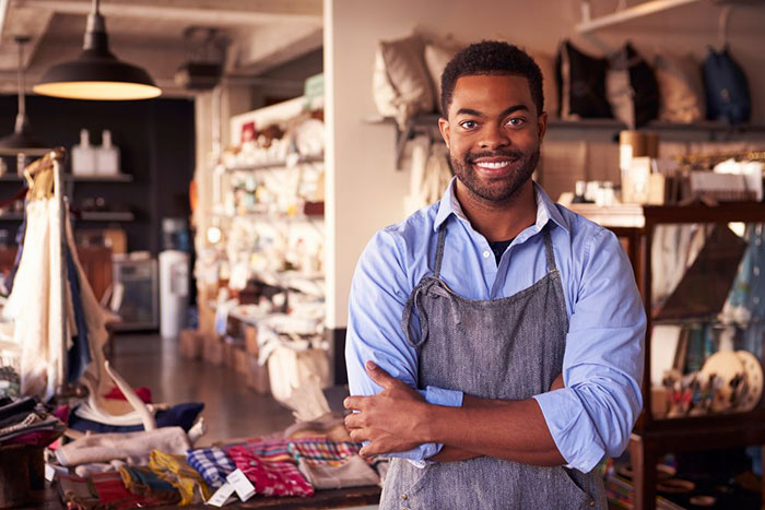 small business owner standing behind counter